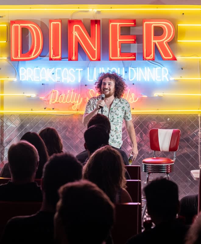 a comedian performing in a diner